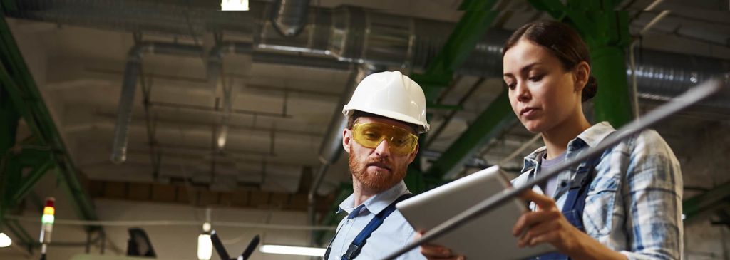 Manufacturing employees checking a tablet