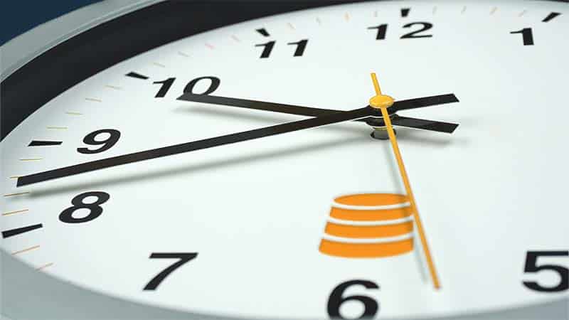 An analog clock face with an icon representing a golden record where the 6 should be.